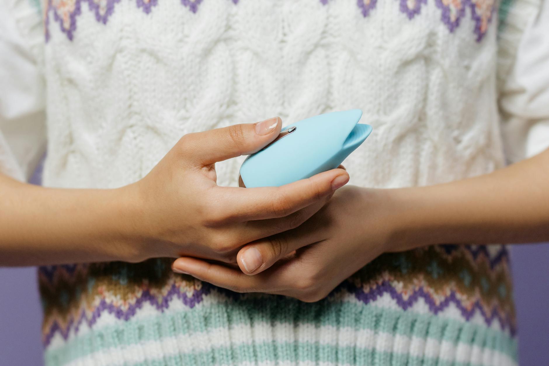 Woman holding blue vibrator with confidence